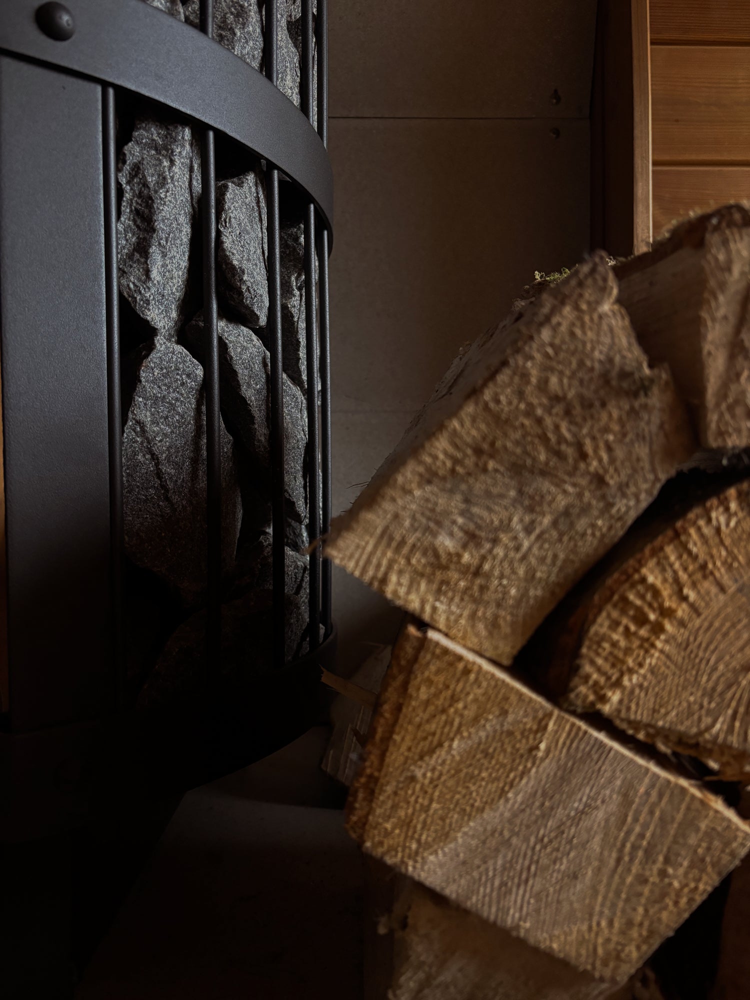 Wood fired Sauna with a stack of logs